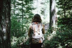 Women with backpack in the forest